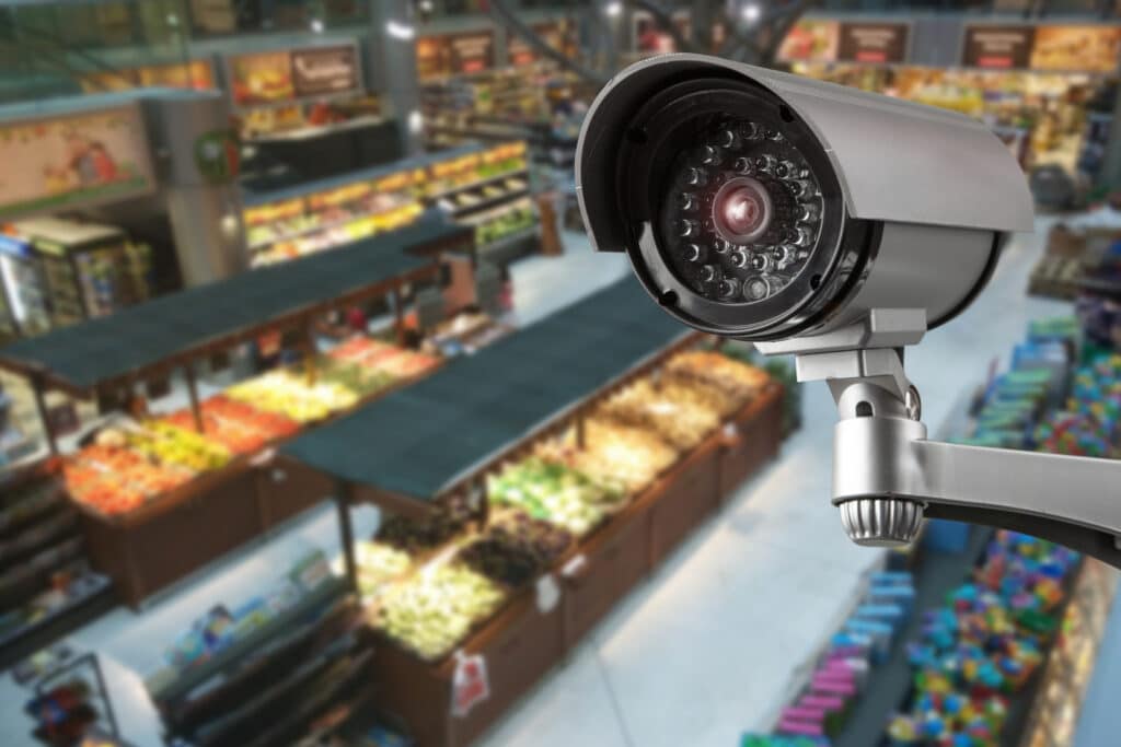 CCTV camera system, which is one of the retail anti-theft devices placed in shopping mall supermarket blur background.